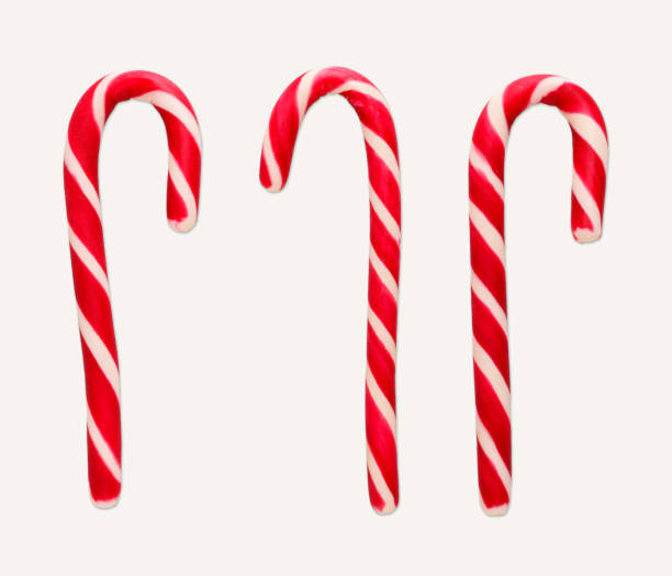 istock Red and white christmas candy canes isolated on white 935476222
