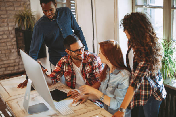 istock Young group of designers negotiates about design 935476512