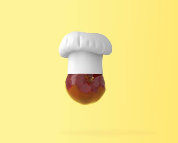 istock Red Apple with Chef hat, fruit concept on pastel yellow background. minimal food idea. An ideas creative to produce work within an advertising marketing communications or artwork design. 935476714