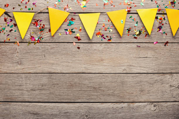 istock Colorful flags garland on wooden background 935479344