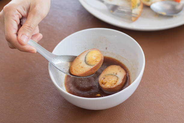 Eggs in brown sauce,Thai Cuisine , Boiled eggs with chicken drumstick in sweet gravy.