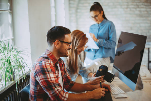 istock Young group of designers negotiates about design 935480254