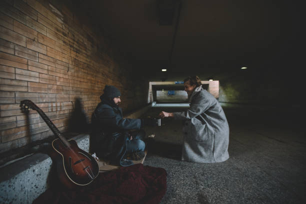 istock Woman helping the homeless guy 935483664
