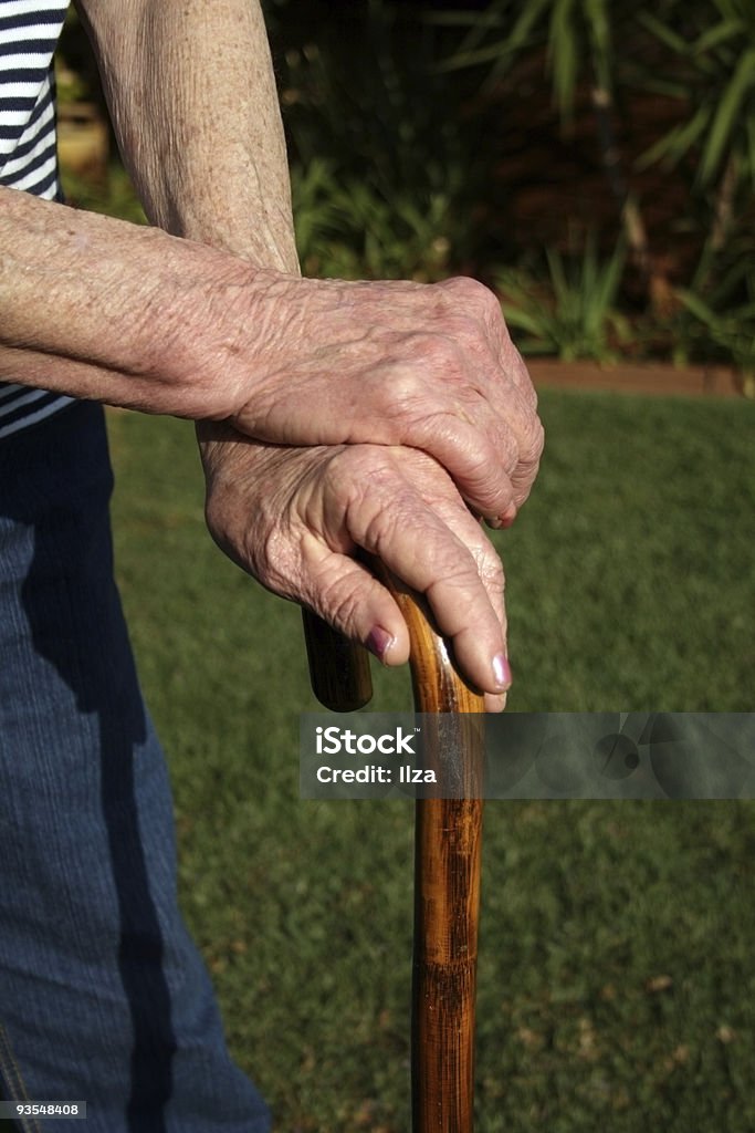 Aging Old woman leaning on a walking cane 70-79 Years Stock Photo