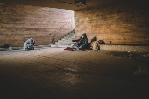istock Homeless man sitting begging 935484336