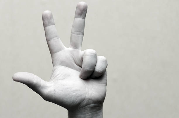 istock Gesture with three fingers up. Black and white image. 935487506