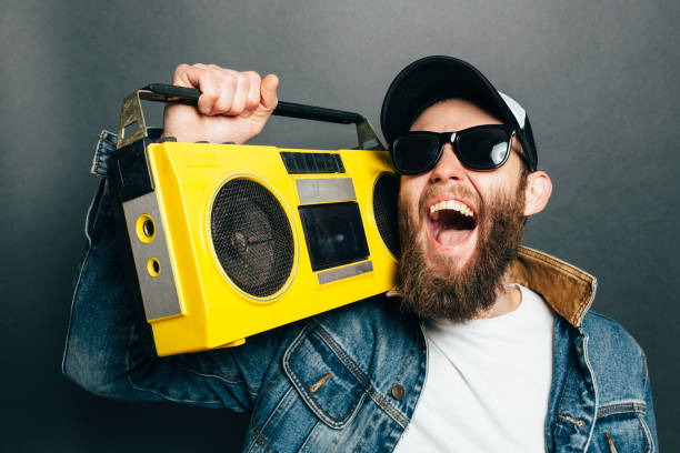 istock Hipster man listening to cassette player and singing along 935488814