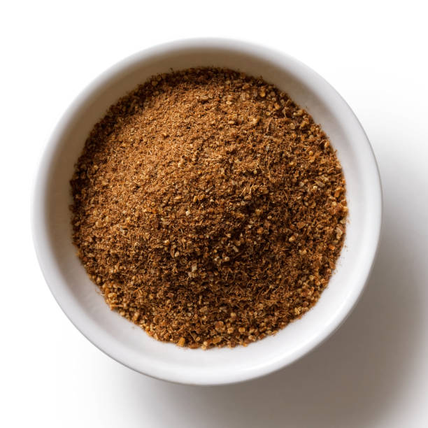 istock Ground cumin in white ceramic bowl isolated on white from above. 935489370