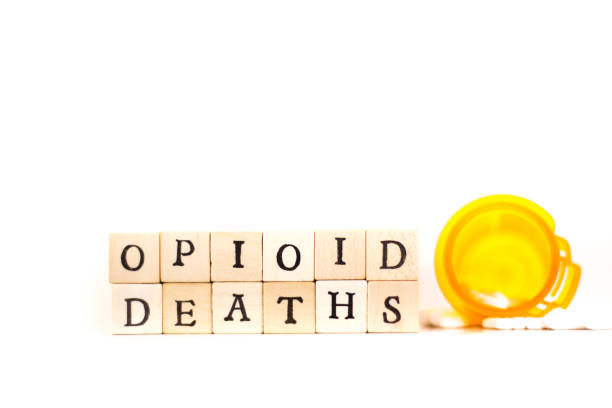 istock OPIOID DEATHS: Written in Wood Block Letters, White Background 935492084
