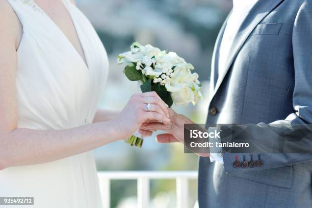 Bride Putting Wedding Ring On Grooms Finger In Wedding Day Stock Photo - Download Image Now