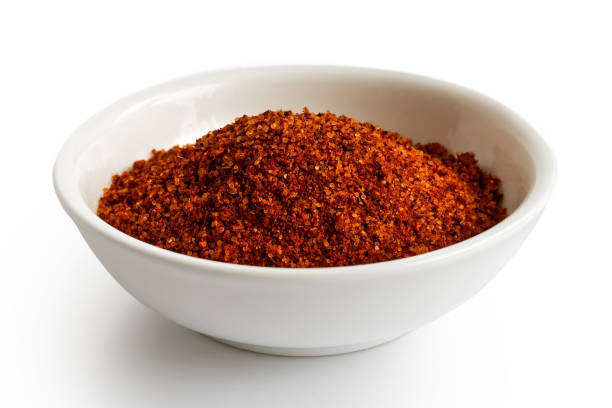istock Red bbq spice mix in white ceramic bowl isoslated on white. 935492844