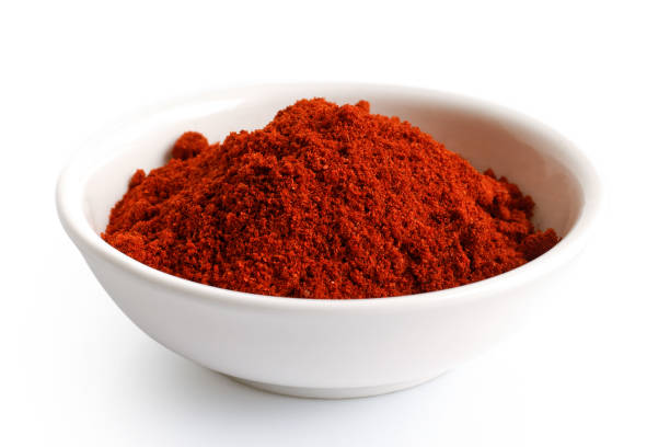 istock Paprika in white ceramic bowl isolated on white. 935493034