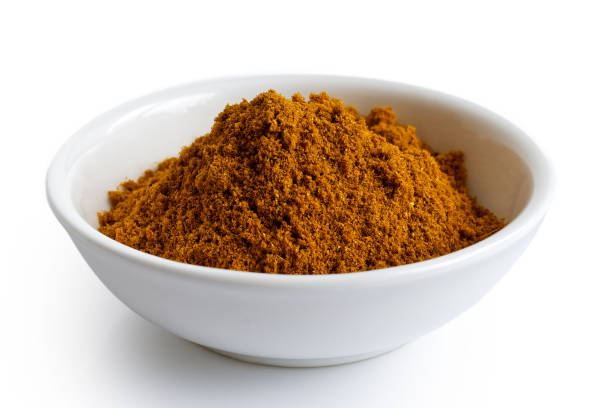 istock Ground ground masala spice mix in white ceramic bowl isolated on white. 935493206