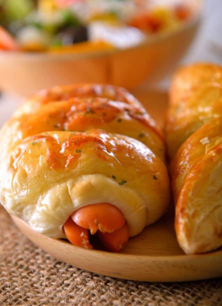 istock sausage bread on wooden background 935498144