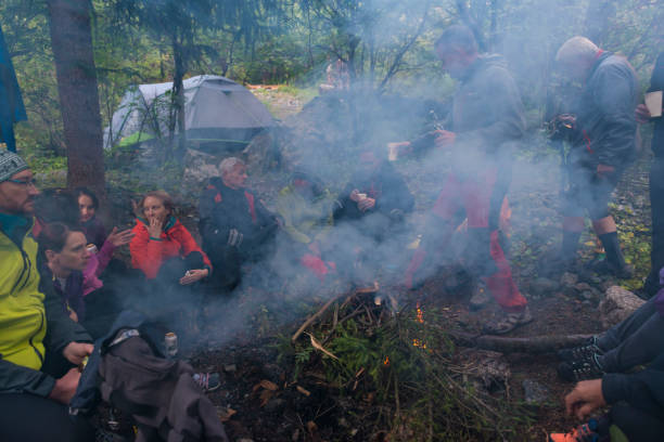 istock People camping at bonfire in forest 935505808