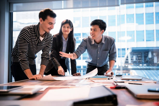 istock Young architests are discussing about mega project at modern office. 935507078