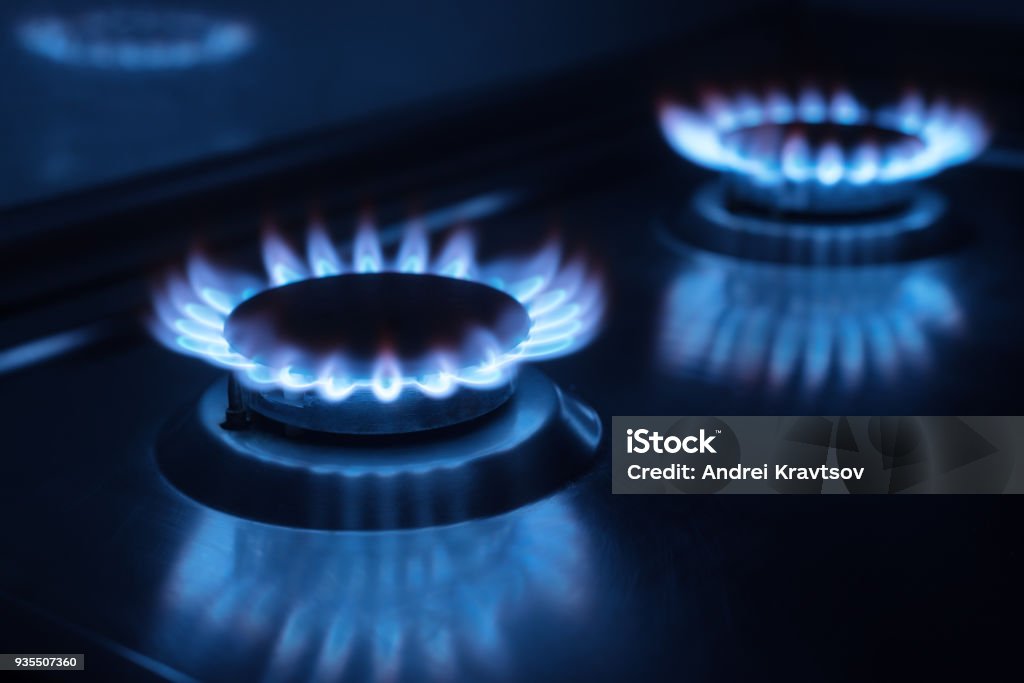 two gas burners in the dark in the kitchen Photo of two gas burners in the darkness in the kitchen Gas Stock Photo