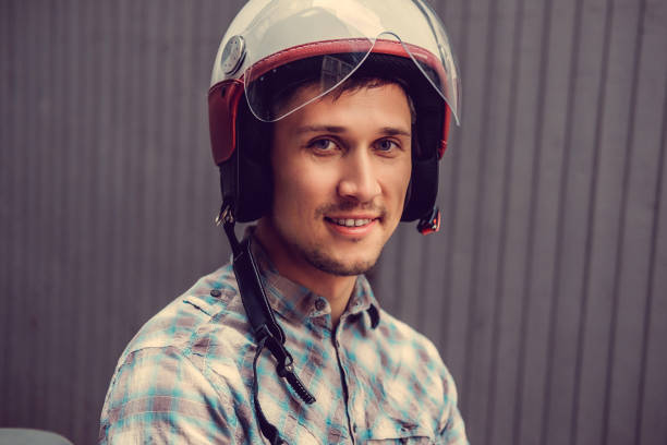 istock Smiling man in retro moto helmet. 935509692
