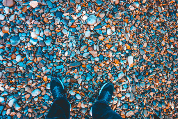 istock man looking down to his shoes on a stone ground 935512350
