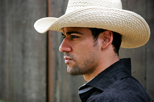 Rugged looking Hispanic cowboy in a southwest setting.