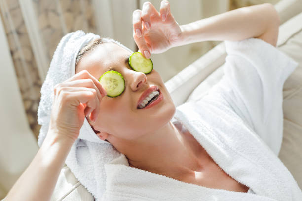 istock woman relaxing with cucumber slices on eyes 935517160