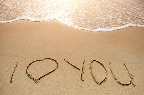 istock Love message written on the sand beach 935518098