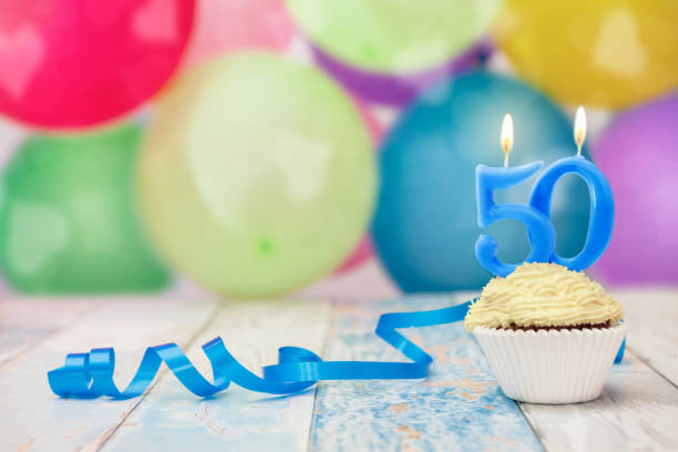 50 anniversary birthday muffin with candle and balloons