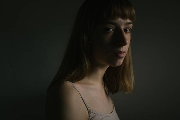 istock Young woman in the dark 935524280