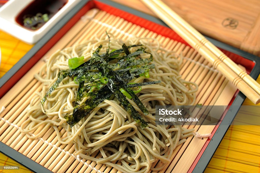 Buckwheat Noodle Buckwheat noodle,soba, served in japanese style with dried seaweed on top and with soba sauce in the background. Chopsticks Stock Photo