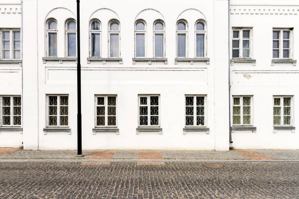 Luxurious old apartament house with a white facade and some windows
