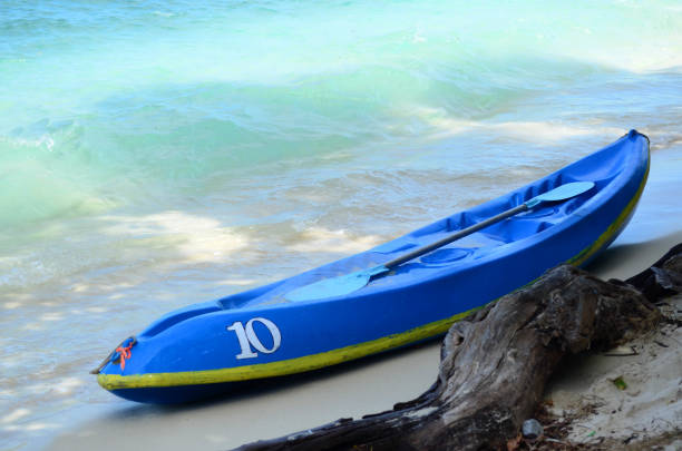 istock Kayak boat on the beach with blue sea 935537660