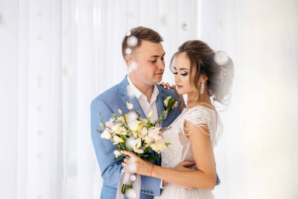 istock The groom hugs the bride in the room. 935539252