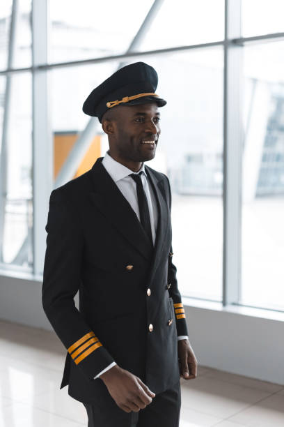 istock happy young pilot in professional uniform at airport 935541956