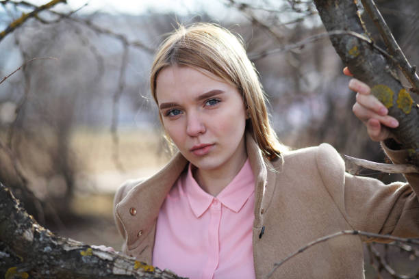 Cute blonde in a city park on a cold sunny day