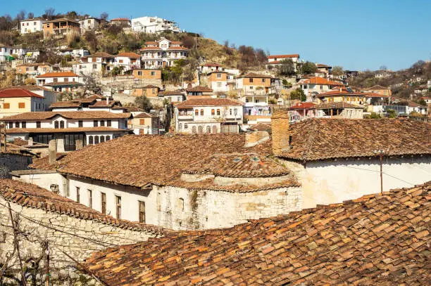 View to Berat, historic city in the south of Albania, during a sunny day. Tiny stone streets and white houses built on a high hill one over another.