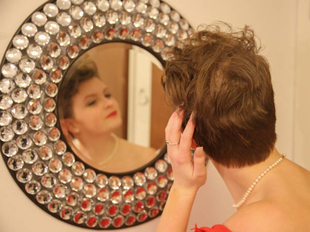 istock Shor Hair Style Teenager Dressing For Prom Looking in Mirror 935558564