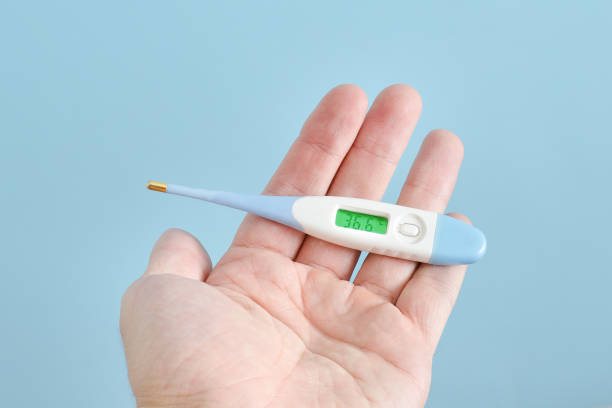 istock Electronic thermometer in a man's hand. Close up 935559652