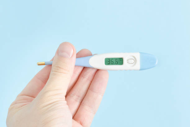istock Electronic thermometer in a man's hand. Close up 935559710