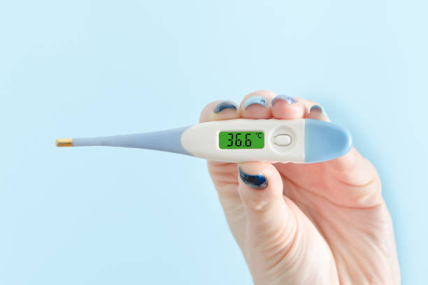 istock Electronic thermometer in a female hand. Normal temperature. Close up 935559714