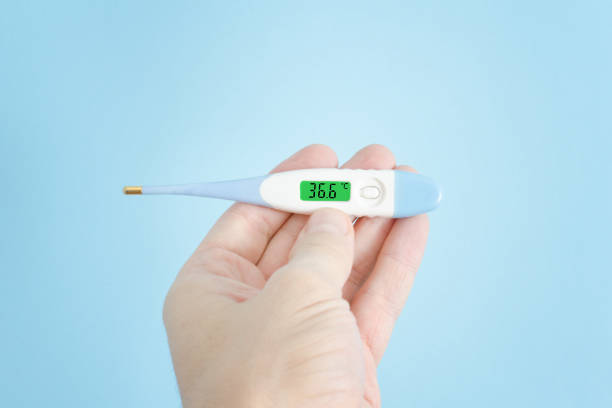 istock Electronic thermometer in a man's hand. Close up 935559728