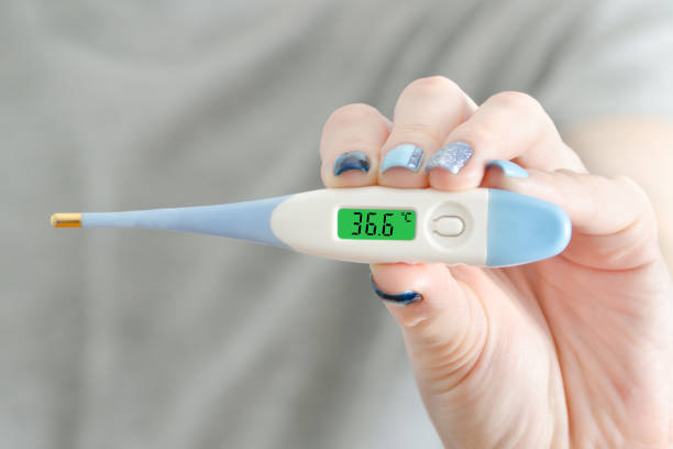 istock Electronic thermometer in a female hand. Normal temperature. Close up 935559742