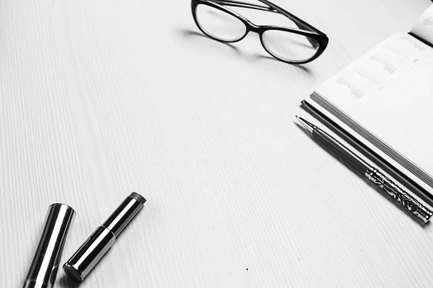 stationery lying on the table black and white poster