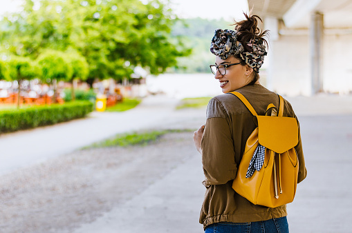 Portrait of young beautiful caucasian brunette woman outdoor in the city