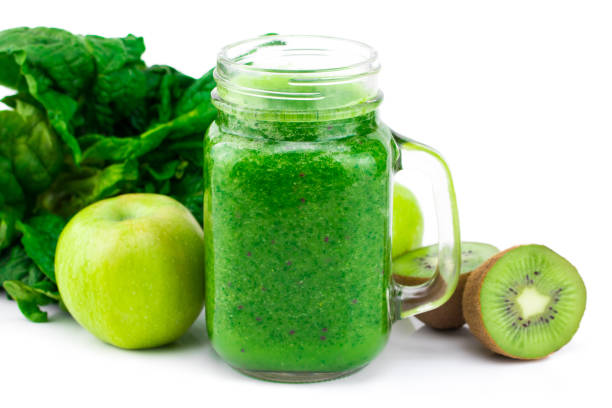 istock Green smoothie with spinach, apple, kiwi  and mint isolated in a jar mug on white background 935567444