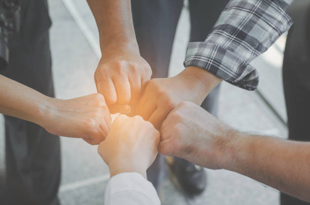 istock teamwork concept of diversity multiethnic people with group hands bump for relationship and together. 935568330