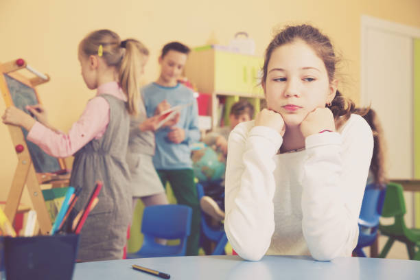 istock Upset girl in schoolroom during break 935572386