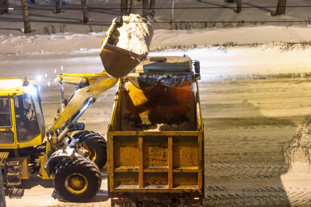 istock loader removes snow in the night 935573434