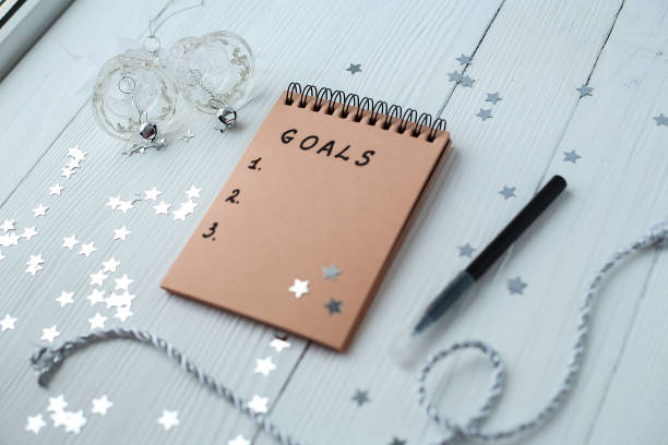 istock A Notepad on a wooden table near the Christmas tree. Notebook to 935573544