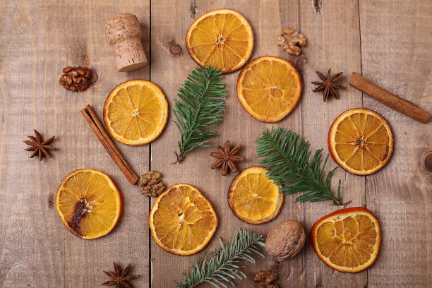 istock Dry slices of oranges lying on the table. Decorative ornament. C 935580340