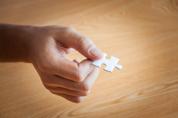 istock Business people assembling jigsaw puzzle and represent team support and help concept in office, business people assembling jigsaw puzzle and represent team support and help concept 935590404